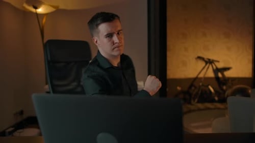 Young Adult Working on Laptop in Cozy Office