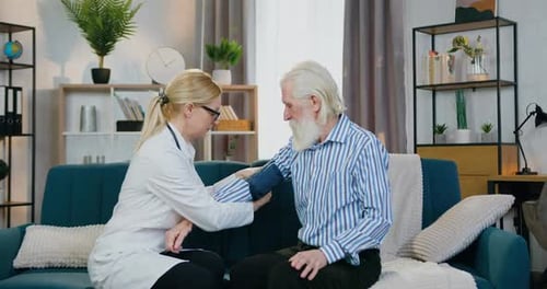 Doctor Checks Senior Man's Blood Pressure at Home