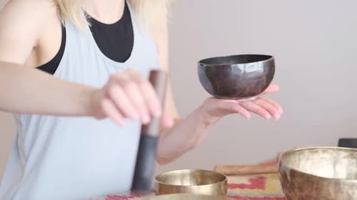 Woman Playing Tibetan Singing Bowl Close Up