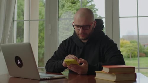 Young Adult Using a Smartphone Indoors