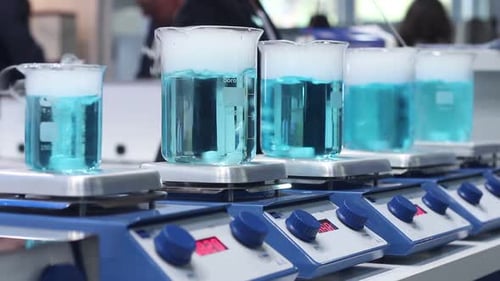 Chemistry Beakers with Blue Liquid on Stirrers