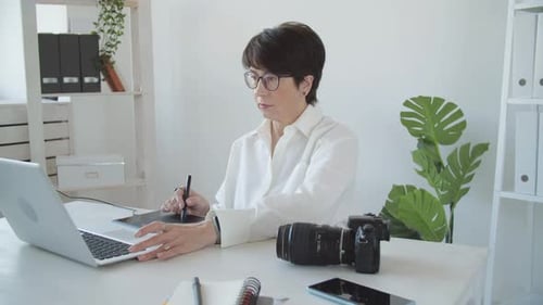 Woman Using Graphic Tablet at Desk