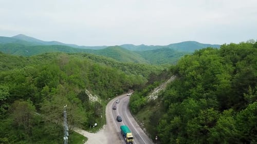 Aerial Fly Over Caucasian Mountains and Winding Road with Cars