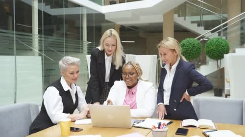 Three Caucasian Women and One African Female Manager Coworking in Light Modern Office, Coworking