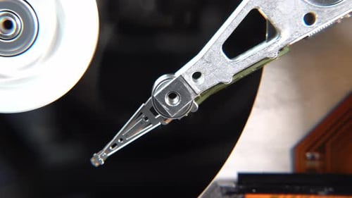 Close-up of an Operating Computer Harddisk Reading and Writing Data
