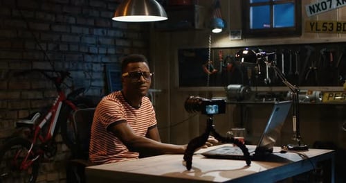 Young Man Talking on Camera in a Garage