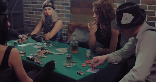 Adults Playing Poker in Dimly Lit Room
