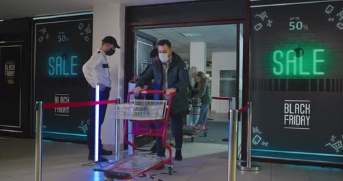 Guard Asking Customers To Disinfect Hands at Mall Entrance