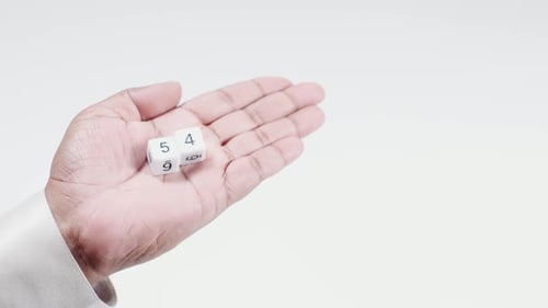 Hand Holds Numbered Dice Five And Four Fifty Four
