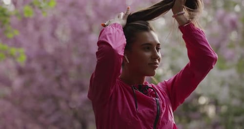 Sporty Woman Make a Ponytail in the Park