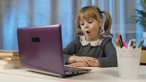 Child at Desk Talking to Laptop