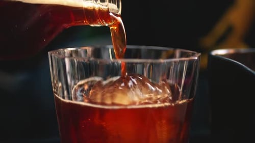 Beverage Poured Into Glass With Ice Cube