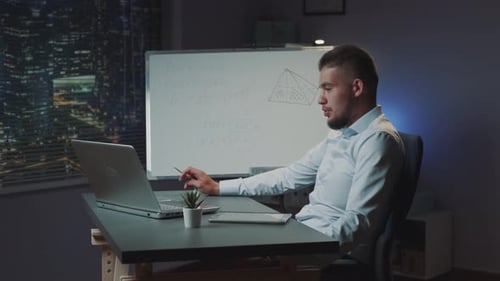 Mixedrace Man with Beard Starting Online Video Conversation on Computer at Office