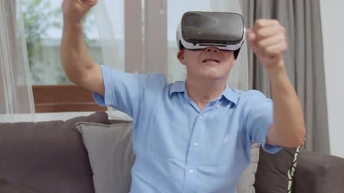 Senior Man Enjoying Virtual Reality Headset on Couch