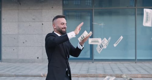 Happy Middle Aged Businessman Throwing Out Dollar Banknotes, Walking Near Office Building Outdoors