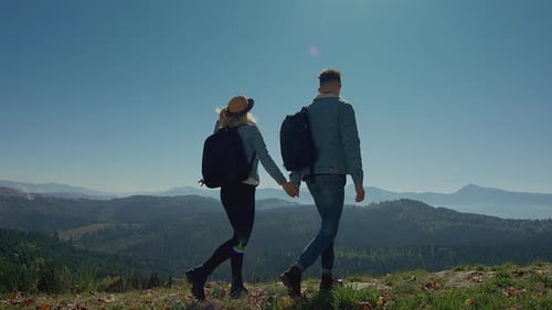 Couple Holding Hands on Mountain Top
