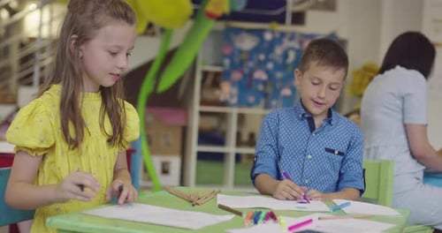 Creative Kids During an Art Class in a Daycare Center or Elementary School Classroom Drawing with