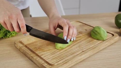 Slicing Fresh Avocado on Cutting Board