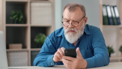 Elderly Business Male Chatting Surfing Internet Use Smartphone at Home Office Workplace