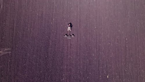 Tractor Tilling Center of Farm Field in the Fall