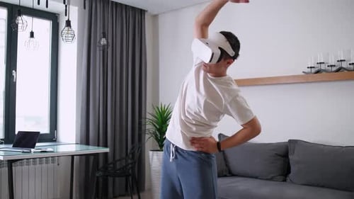 Man Using VR Headset to Exercise at Home