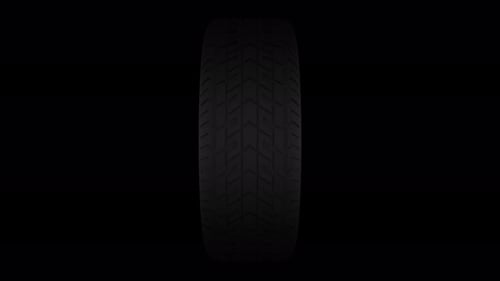 Realistic Car Tire Rotating on Black Background Loop
