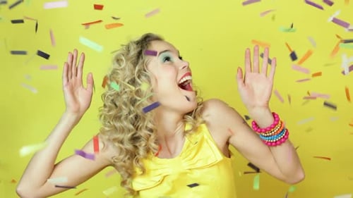 Woman Surrounded by Confetti Receives a Happy Surprise