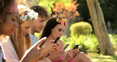 A group of hipster friends looking on their smartphone