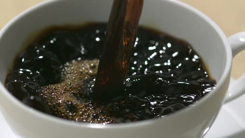 Coffee Pouring Into a White Coffee Mug