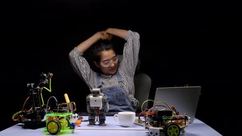 Young Adult Working With Robotics and Technology