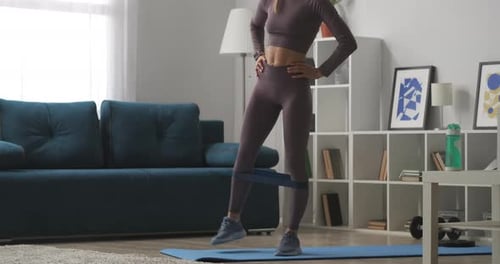 Woman Exercising at Home with Resistance Band