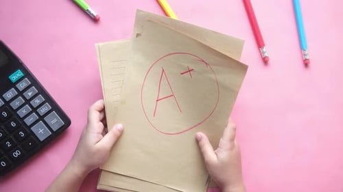 Hand Holding Paper with Hand Drawn Grade with Plus in Circle