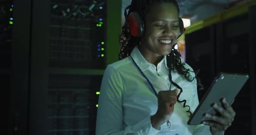 Smiling Data Center Technician Using Tablet Device
