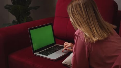 Close Up Smiling Businesswoman Lying on Sofa and Working Laptop Green Screen Chromakey at Home