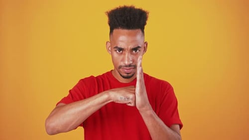 Young Adult Strikes a Fighting Pose in Studio