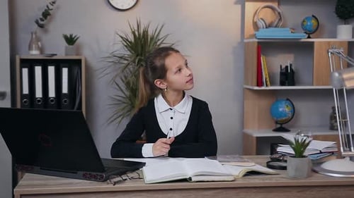 Dreamy Pretty Teen Girl in School Uniform Writing a Work at Home