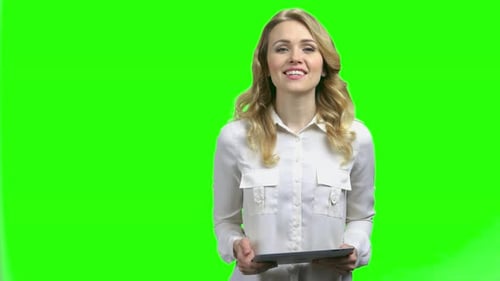 Woman Using Tablet in Front of Green Screen