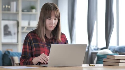 Woman Using Laptop is Surprised at Home