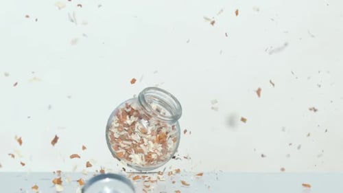 Jar with flakes falling after explosion, Ultra Slow Motion