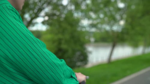 Stylish Woman Scooter Ride Through Urban Green Park