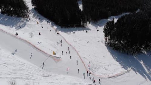 Aerial View Crowd of Skiers Skiing on Peak Ski Slope Near Ski Lifts. Ski Resort