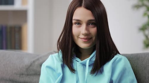 Attractive Young Woman Smiles at the Camera