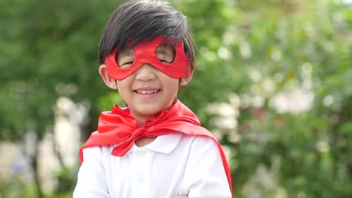 Asian Child In In Superhero Costume Playing In The Park Slow Motion