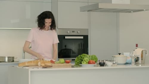 Woman Cuts Fresh Vegetables in Modern Kitchen