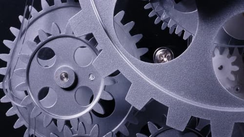 Abstract Gear System Turning Against Black Background