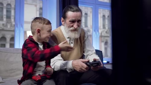 Grandfather and Grandson Playing Video Games Together