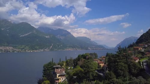 Aerial Flying Over Mountain Lake Como in Italy, Lakeside Villages and High Mountains on Horizon