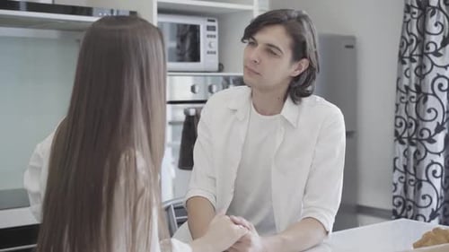 Affectionate Couple Holding Hands in Kitchen