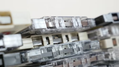 Retro data analogue magnetic tapes stacked 4K 2160p 30fps UltraHD tilting footage - Close-up of m