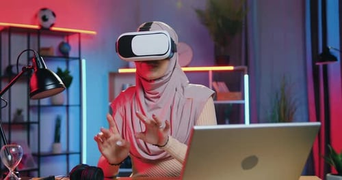 Woman Using VR Headset at Desk